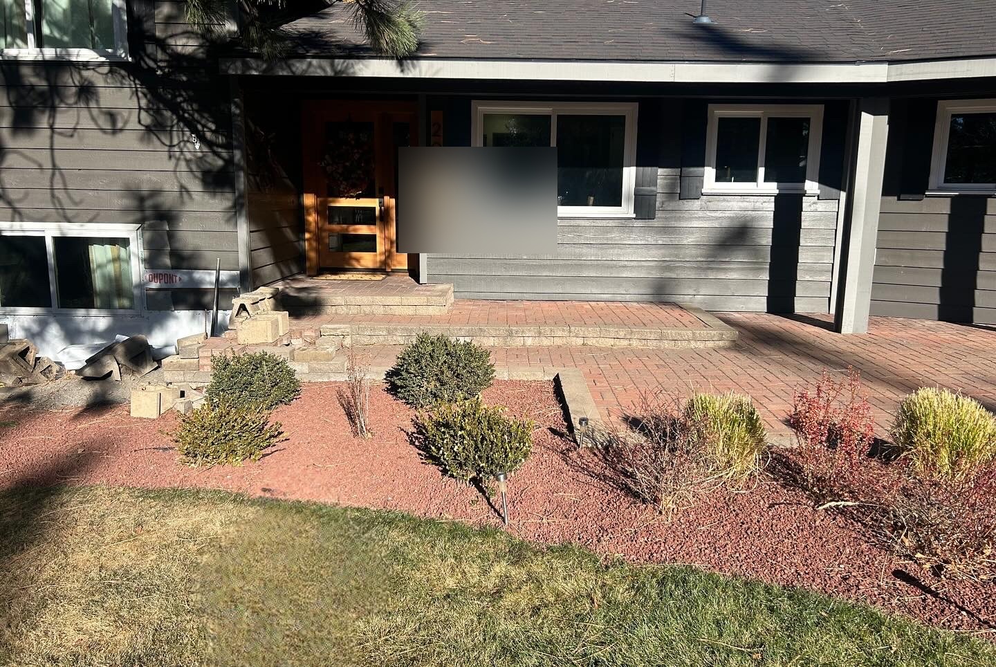 Front entrance before renovation — old brick steps and bare plantings