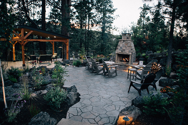 Westside outdoor living space with cedar deck, water feature, and outdoor fireplace — Bend, Oregon